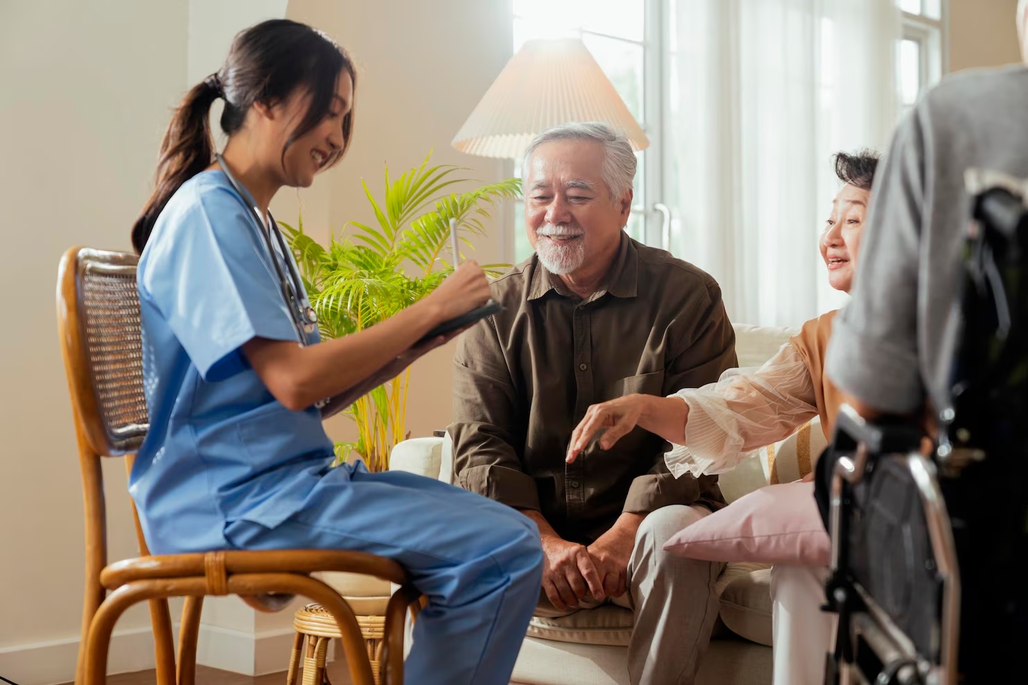 Happiness cheerful elderly woman and men talking with female caregiver